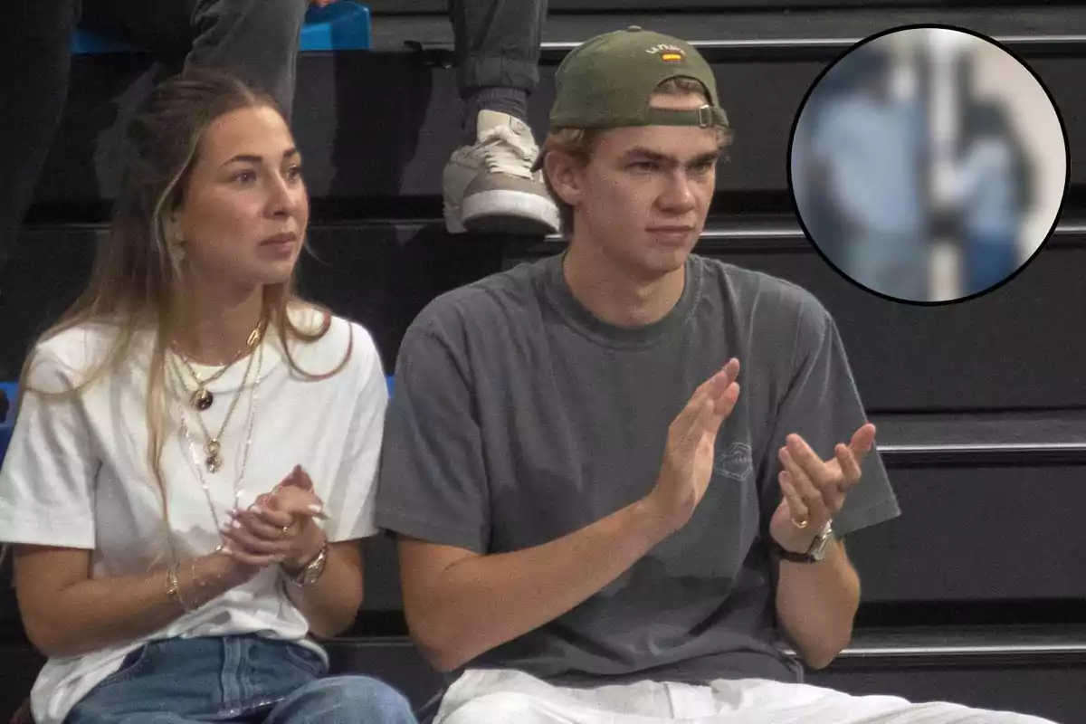 Miguel Urdangarin y Olympia Beracasa en las gradas aplaudiendo mientras observan algo fuera de cámara con una imagen borrosa en un círculo en la esquina superior derecha