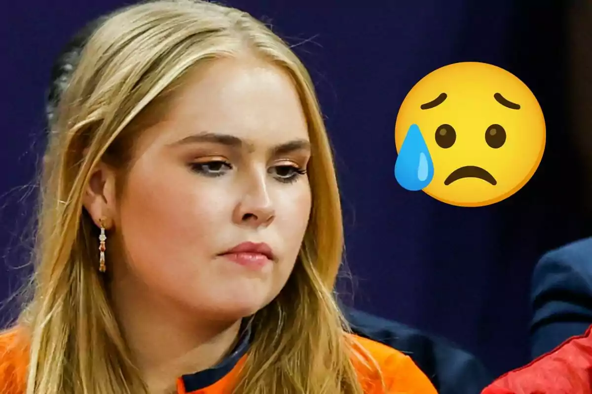 Amalia de Holanda con expresión seria y un emoji de carita triste con lágrima a su lado