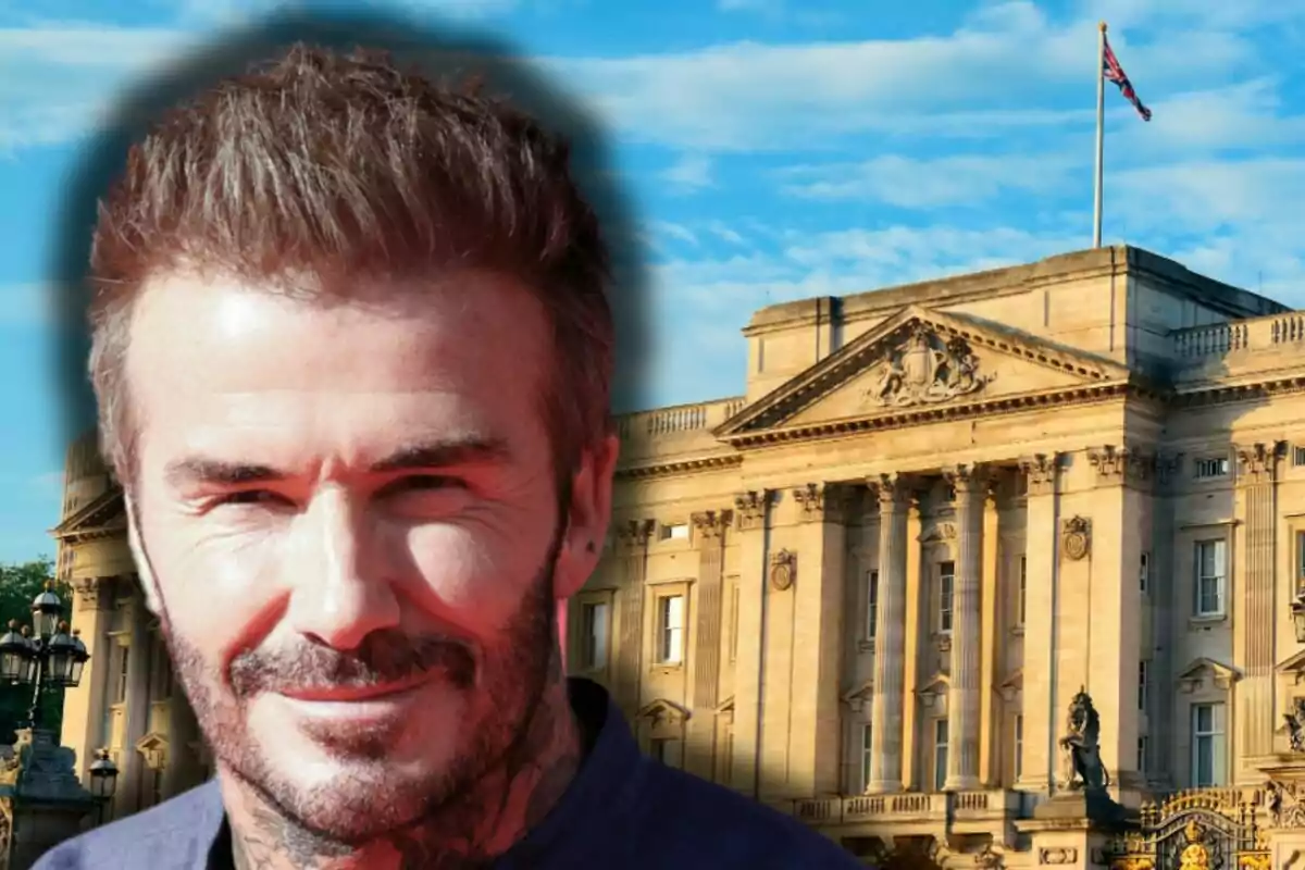 David Beckham sonriente con barba al frente de un edificio histórico con bandera británica ondeando en la parte superior