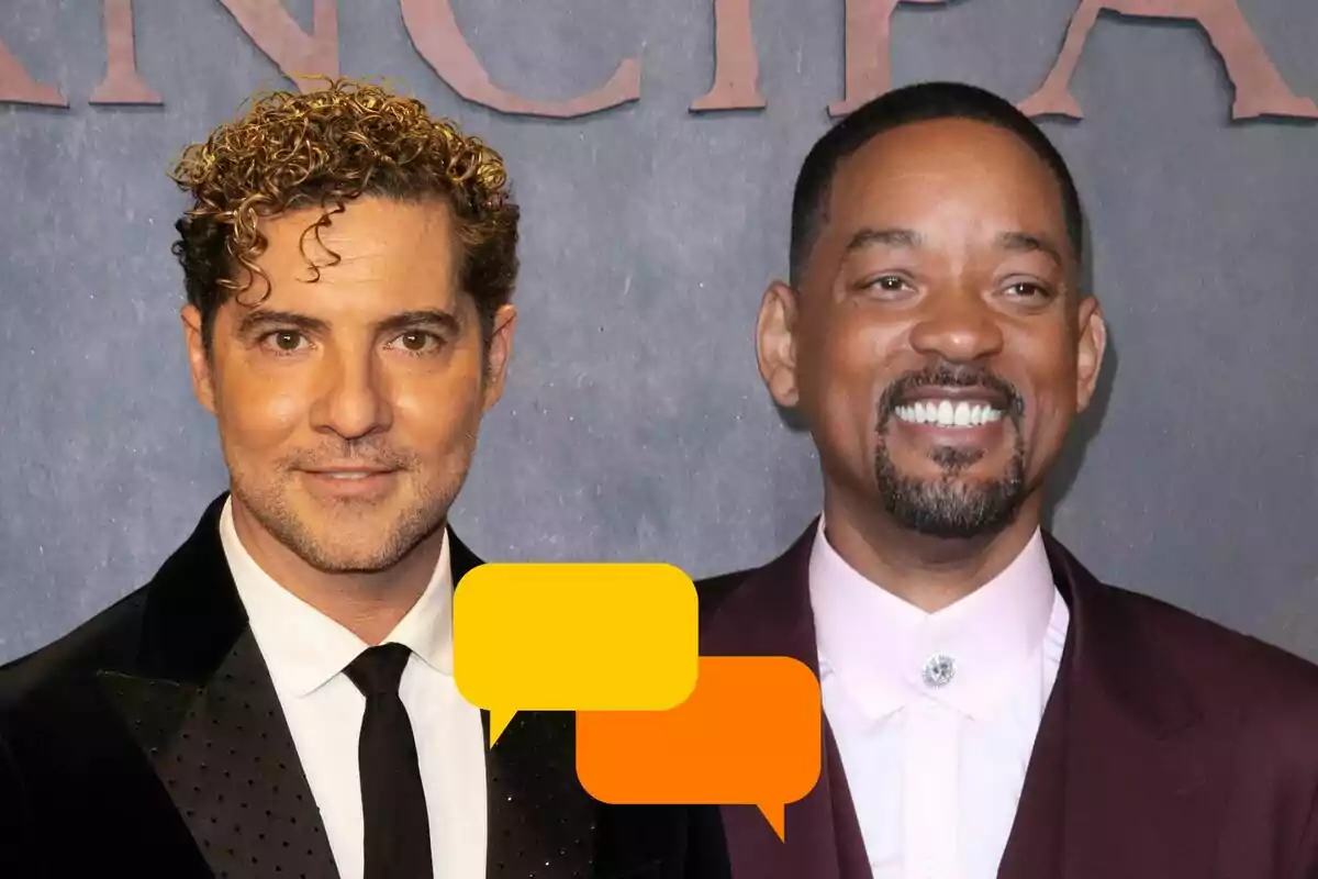 David Bisbal y Will Smith posando en un evento formal, David con traje negro y Will con traje burdeos, ambos sonriendo frente a un fondo gris con letras grandes.