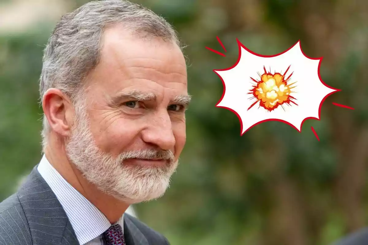 Felipe VI, wearing a suit and tie, smiles while next to him appears a comic-style explosion illustration.