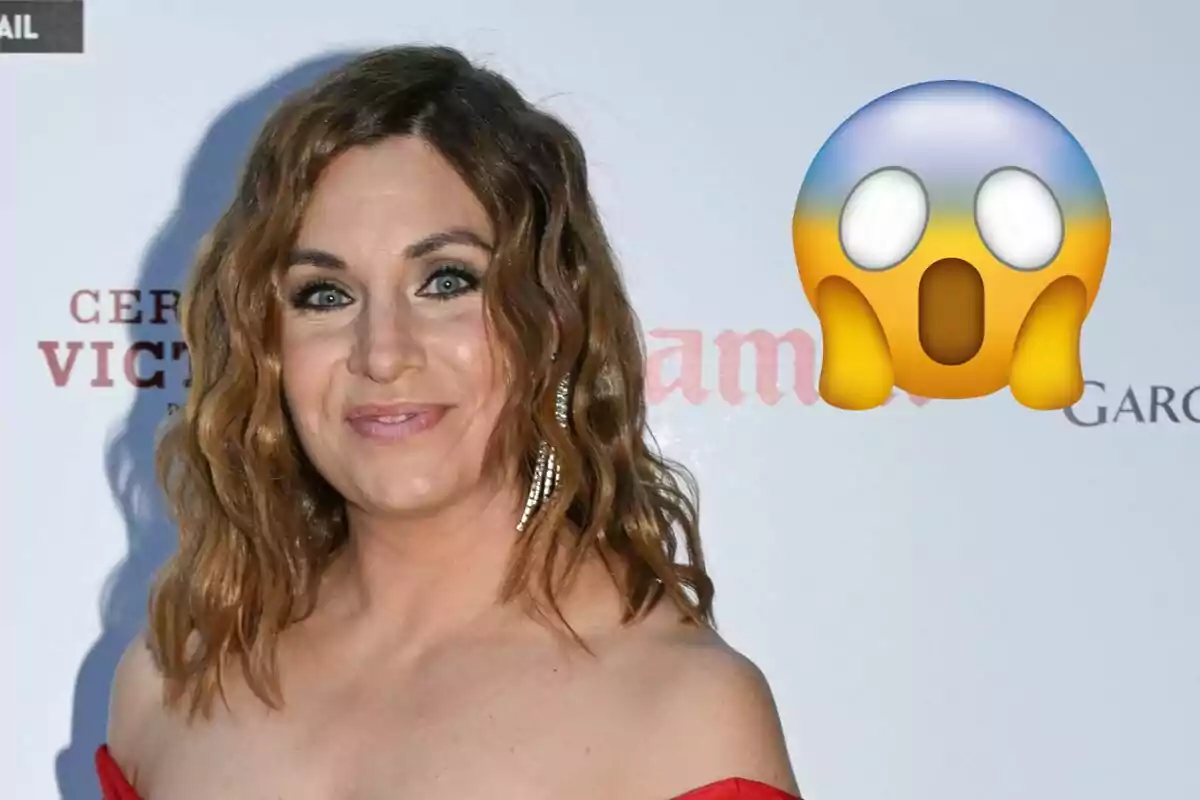 Leire Martínez con cabello rizado y un vestido rojo posando frente a un fondo con texto y un emoji de sorpresa al lado.