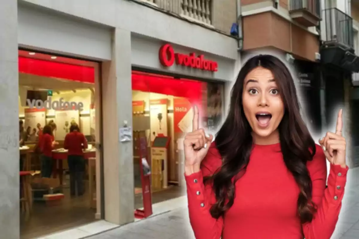 A woman with a surprised expression and pointing up in front of a Vodafone store.