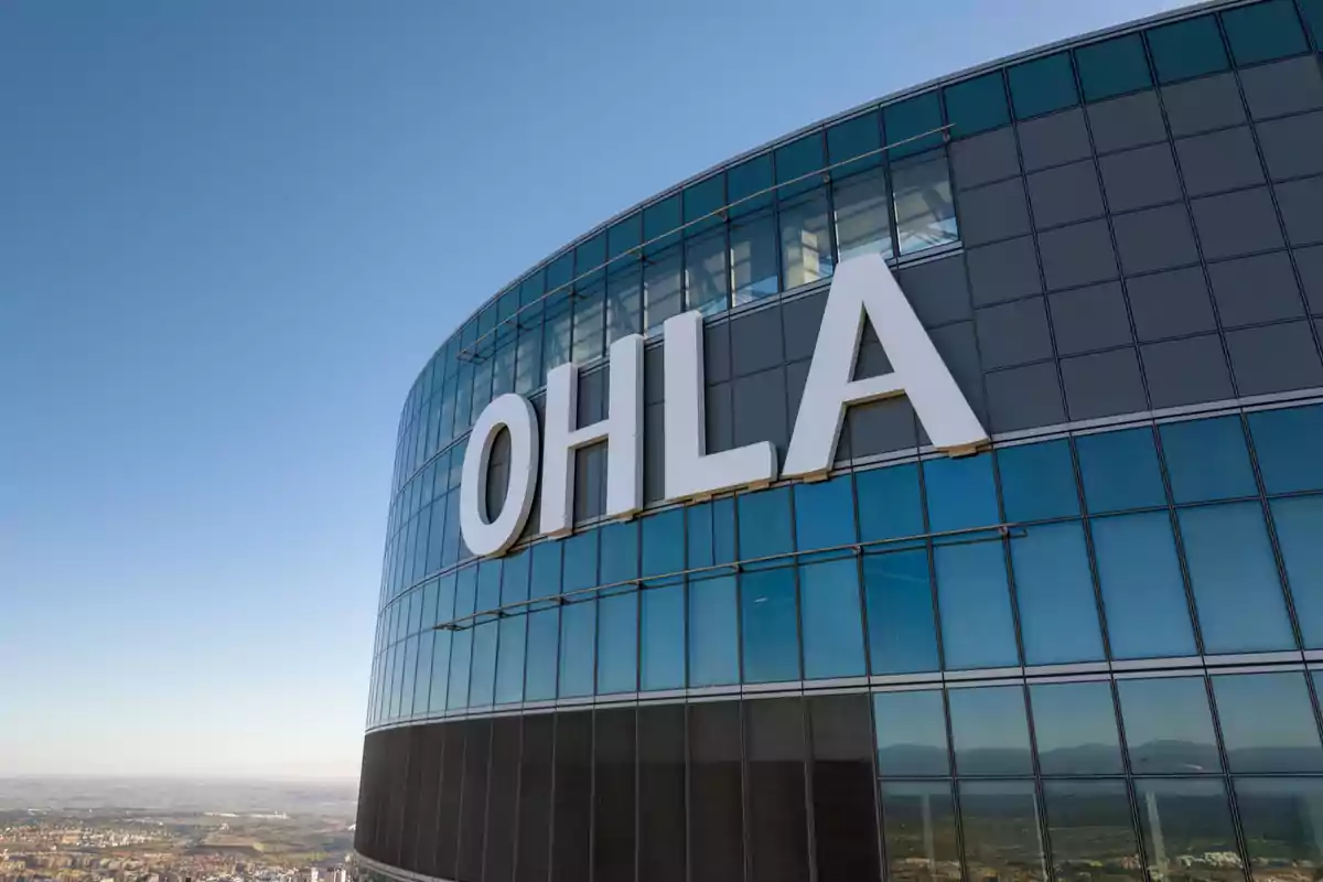 Modern building with a glass facade and large letters that say OHLA.