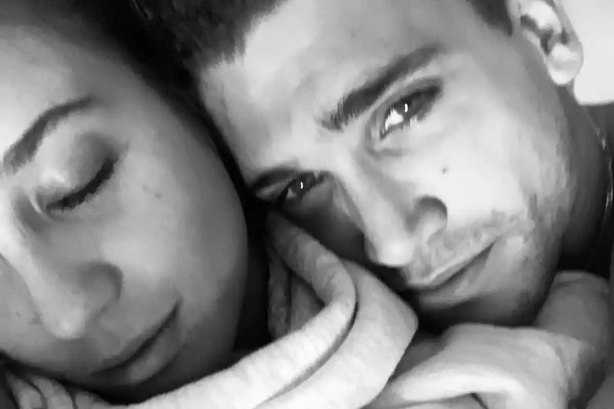 Marta Goenaga y Jaime Lorente abrazada en primer plano en una imagen en blanco y negro donde ambos lucen tranquilos y cercanos Marta Goenaga y Jaime Lorente abrazada en primer plano en una imagen en blanco y negro donde ambos lucen tranquilos y cercanos