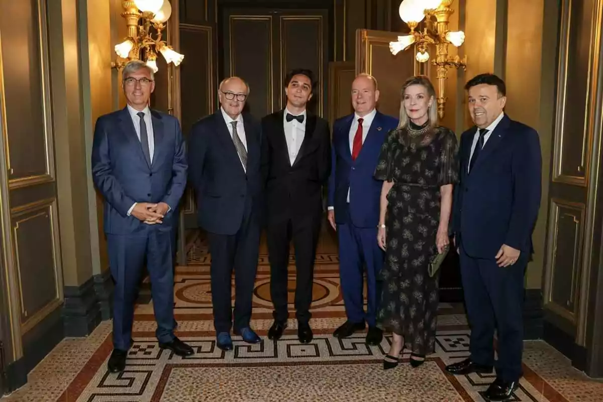 A group of six people dressed formally posing in an elegant interior with lamps and a mosaic floor. A group of six people dressed formally posing in an elegant interior with lamps and a mosaic floor.