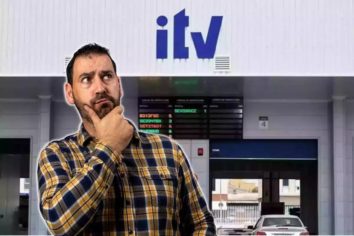 Hombre preocupado mirando hacia arriba y taller de ITV de fondo