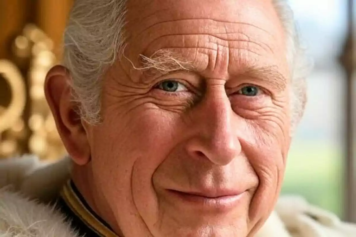 Close-up of King Charles III with a smiling expression and a blurred golden background. Close-up of King Charles III with a smiling expression and a blurred golden background.