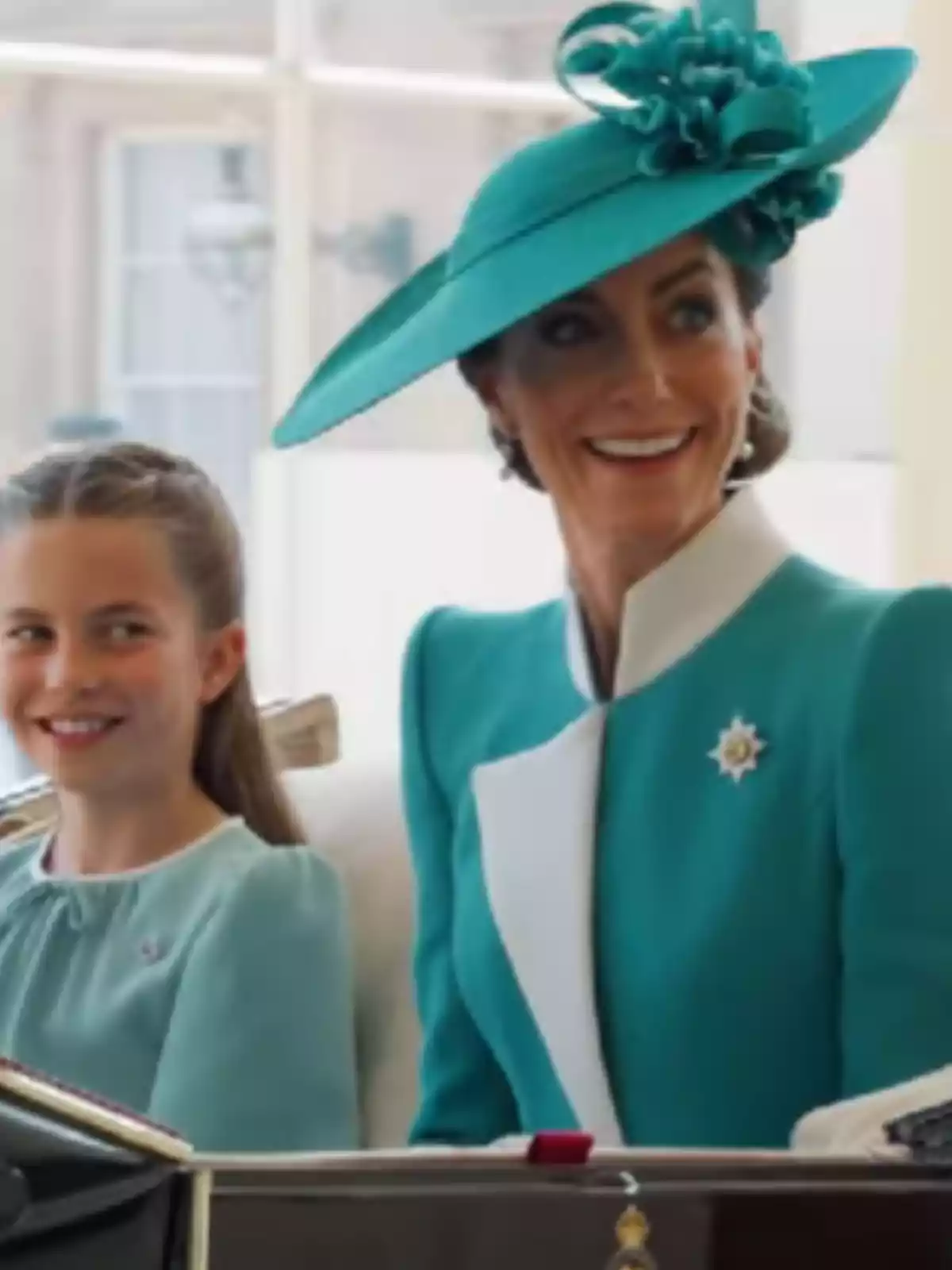 Two people, elegantly dressed in turquoise blue, smile as they ride in a carriage. Two people, elegantly dressed in turquoise blue, smile as they ride in a carriage.