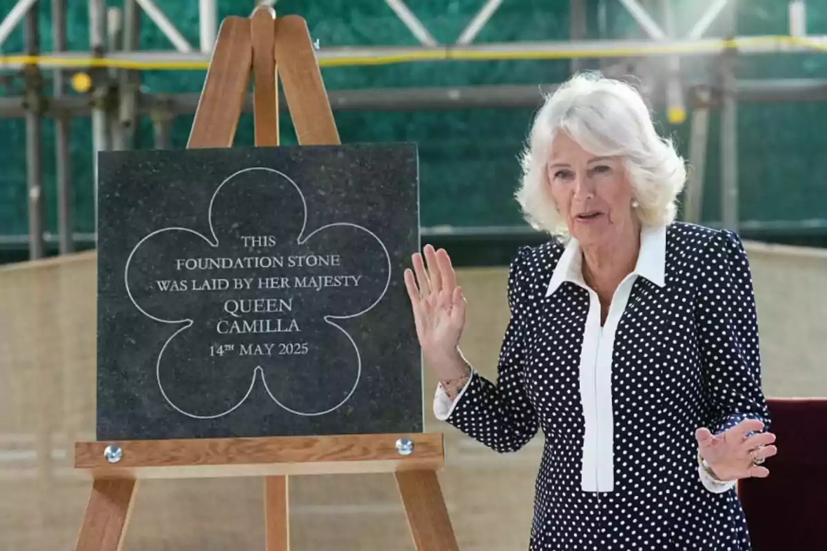 Queen Camilla standing next to a commemorative plaque at a groundbreaking event. Queen Camilla standing next to a commemorative plaque at a groundbreaking event.