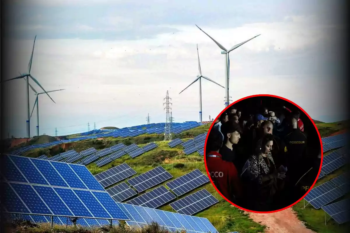 Un campo de paneles solares y turbinas eólicas con un círculo rojo que muestra a un grupo de personas.