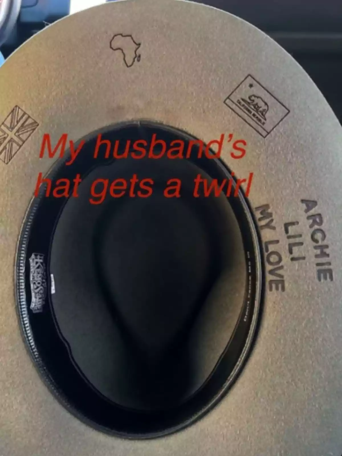 A hat with inscriptions and symbols, including a map of Africa and flags, with a message in red letters. A hat with inscriptions and symbols, including a map of Africa and flags, with a message in red letters.