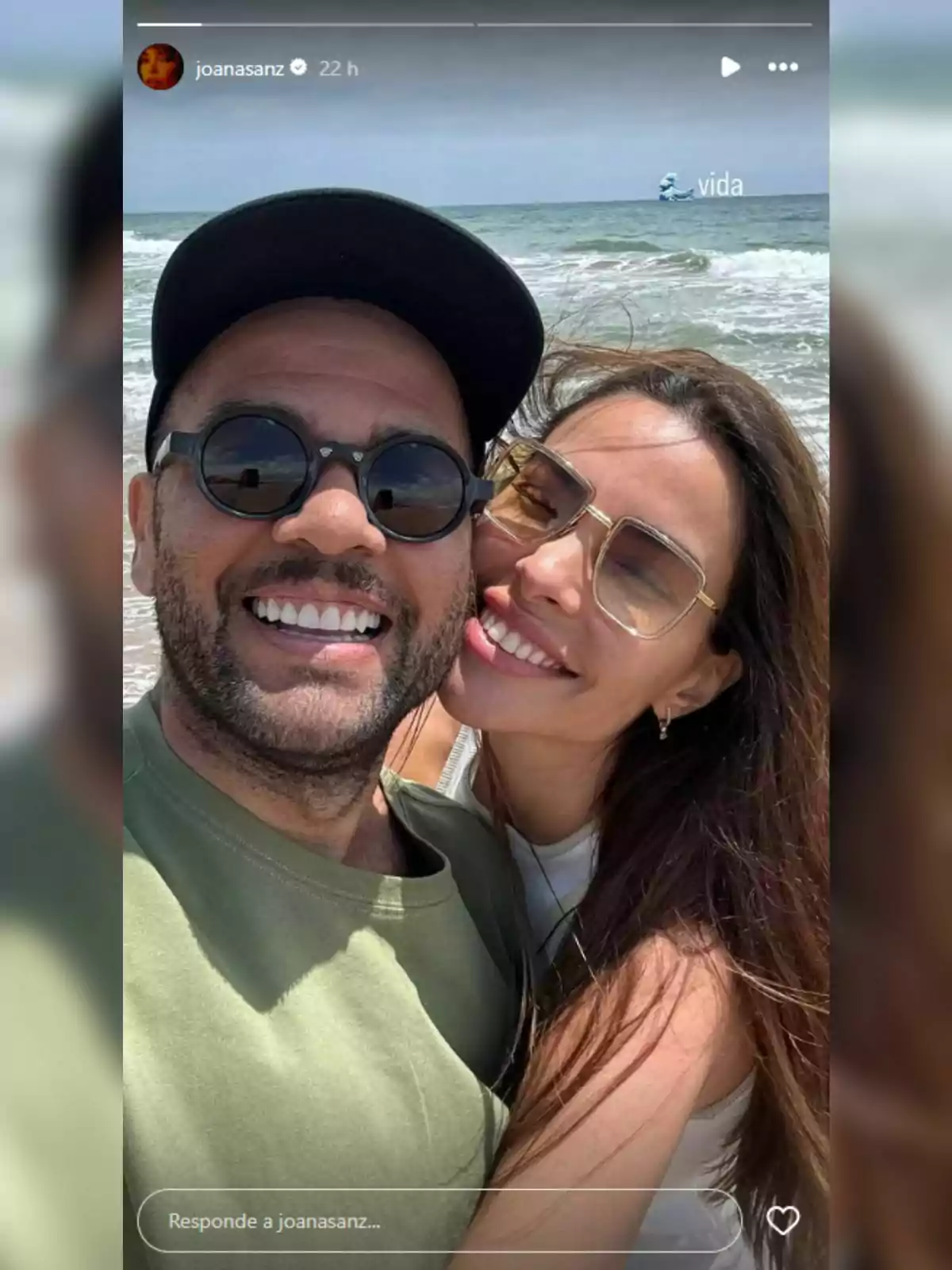 Dani Alves and Joana Sanz smiling take a selfie on the beach with the sea in the background. Dani Alves and Joana Sanz smiling take a selfie on the beach with the sea in the background.