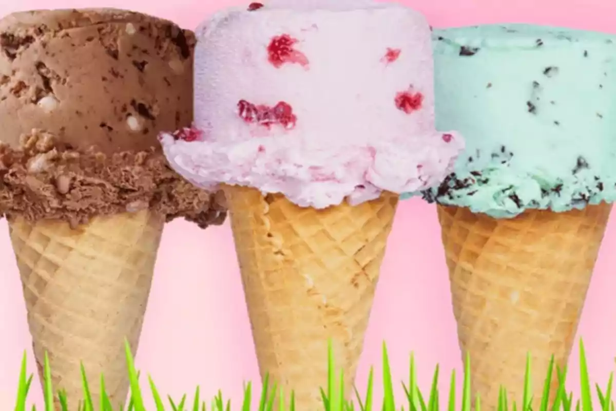 Three ice cream cones of different flavors on a pink background with green grass at the bottom Three ice cream cones of different flavors on a pink background with green grass at the bottom