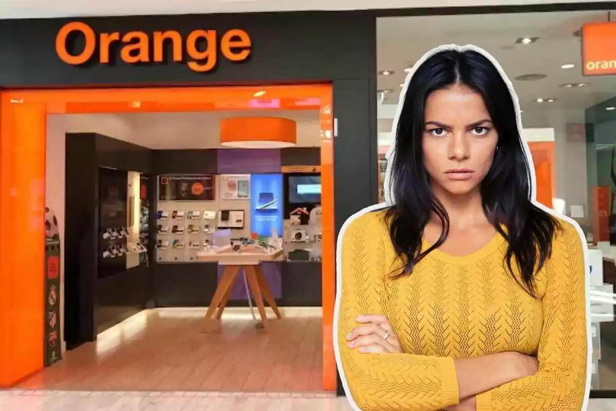 Una mujer con expresión seria está frente a una tienda de la compañía Orange.