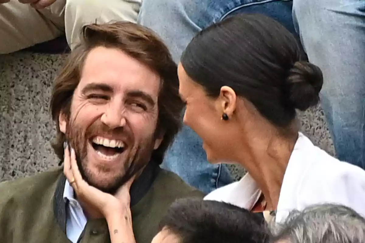 A couple smiles and enjoys a joyful moment together at an outdoor event. A couple smiles and enjoys a joyful moment together at an outdoor event.
