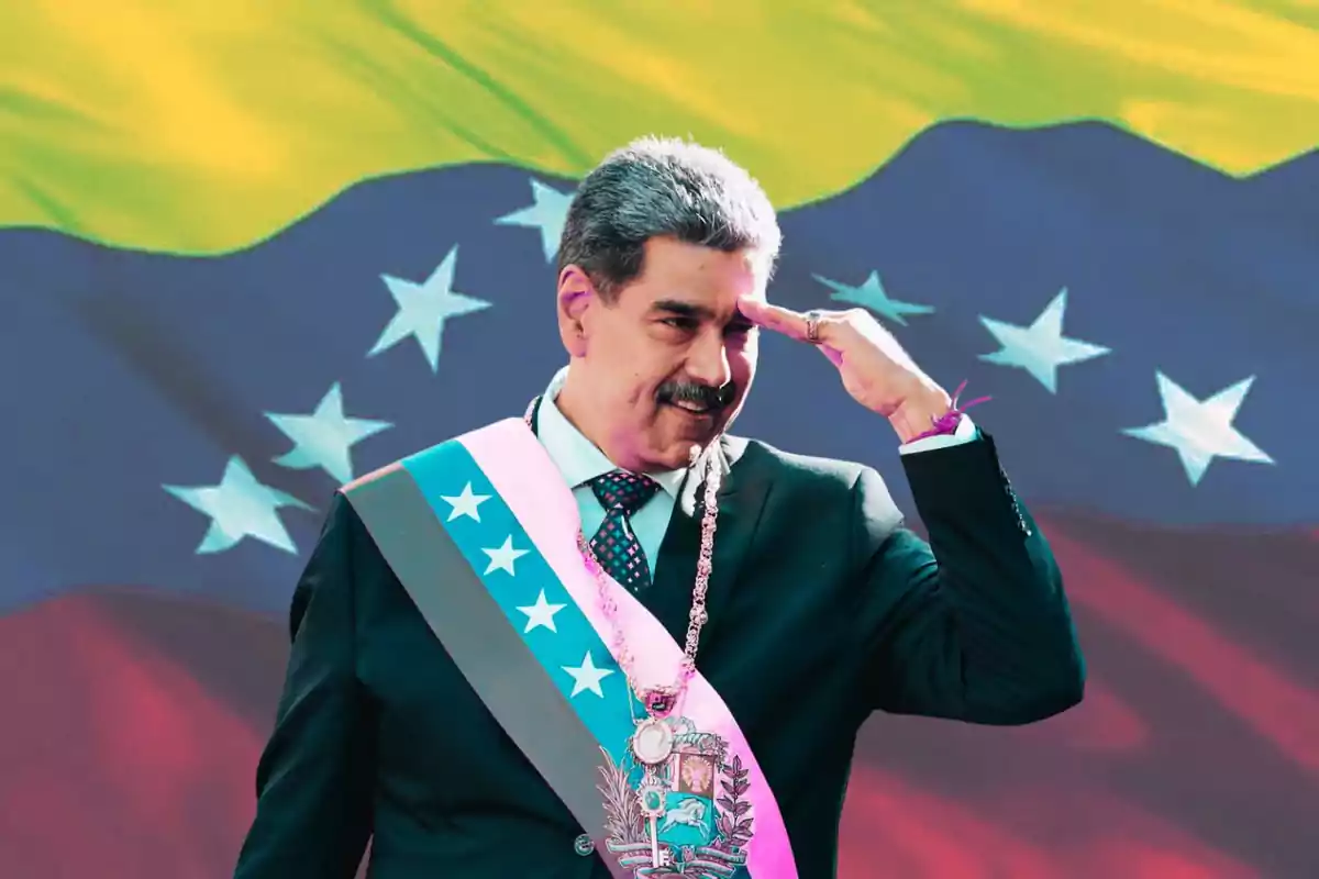 A man in a suit and presidential sash waves in front of a Venezuelan flag.