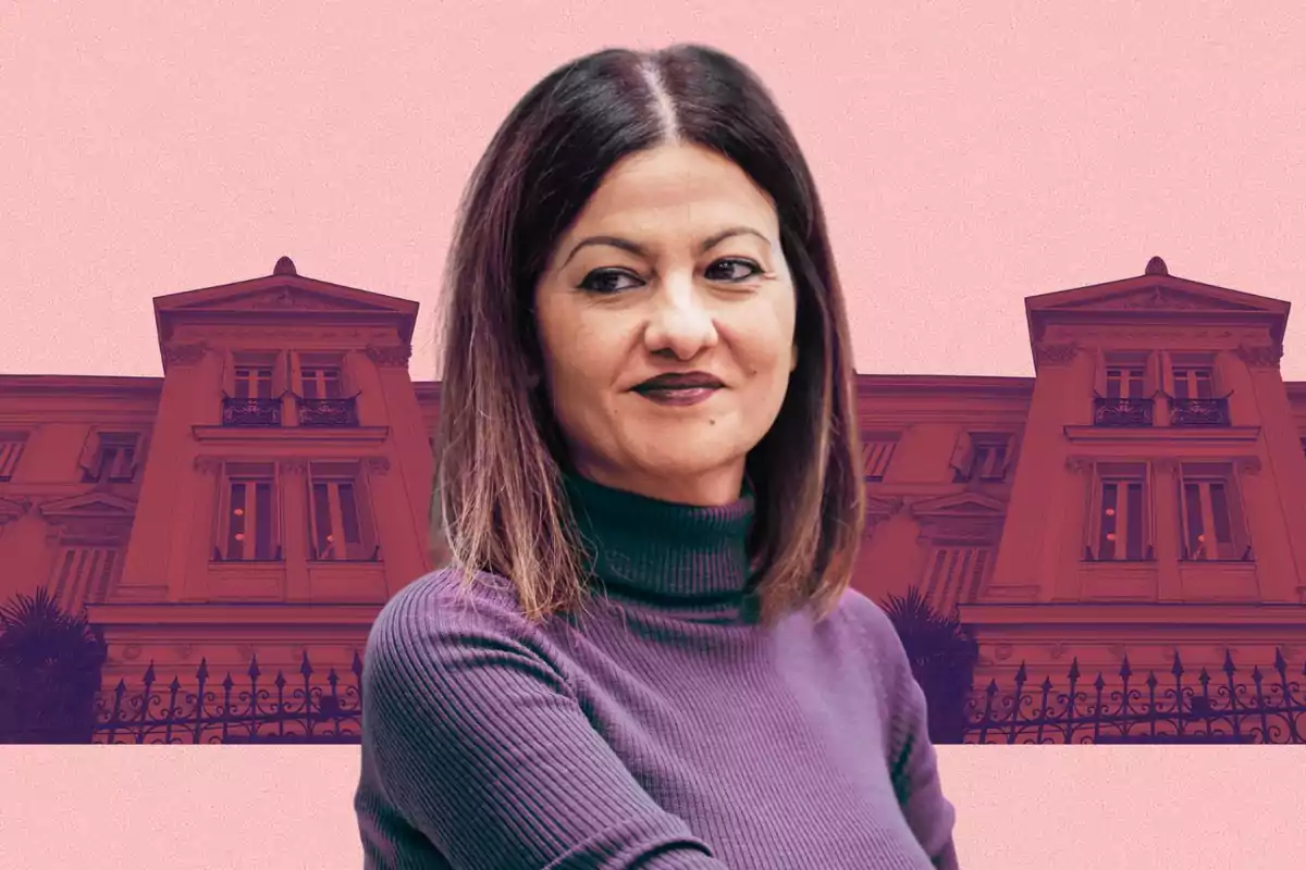 Woman in a purple sweater in front of an old building with a pink background.