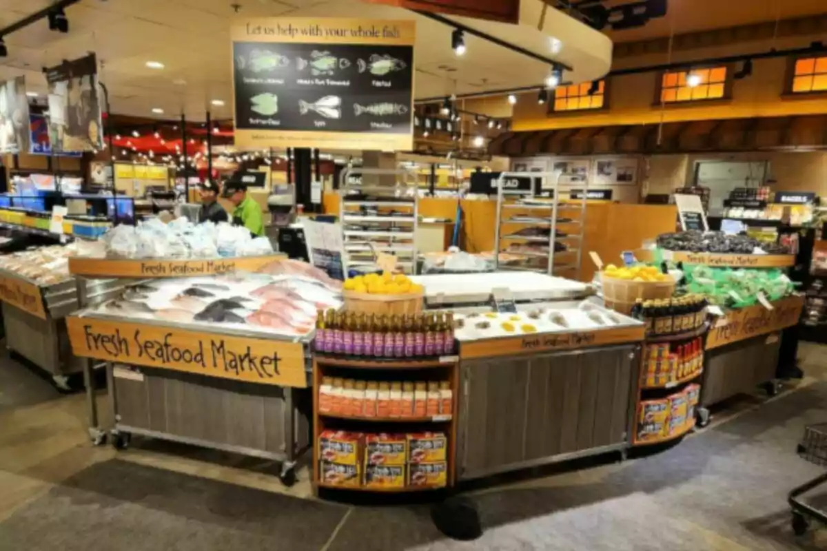 Fresh fish and seafood counter in a supermarket with seafood displayed on ice and various condiments and lemons around. Fresh fish and seafood counter in a supermarket with seafood displayed on ice and various condiments and lemons around.