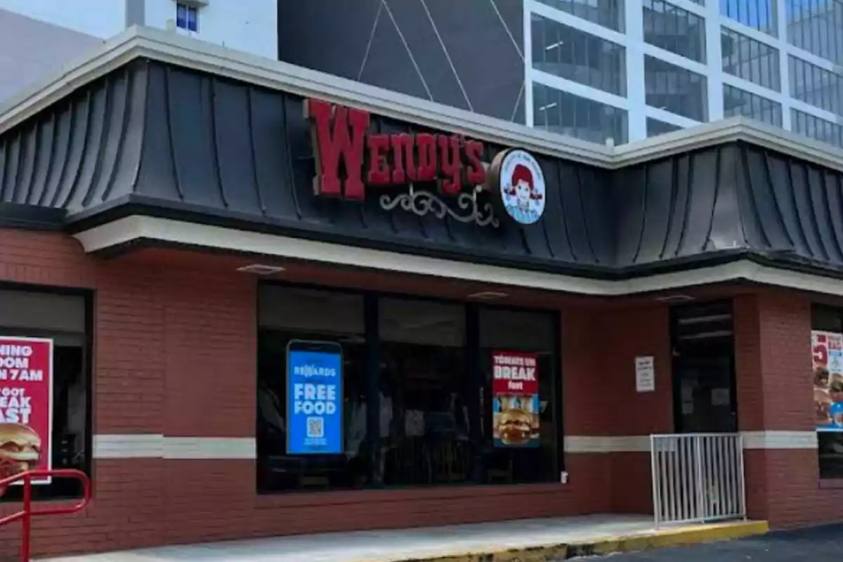 Facade of a fast food restaurant with a red sign and windows with promotional posters. Facade of a fast food restaurant with a red sign and windows with promotional posters.