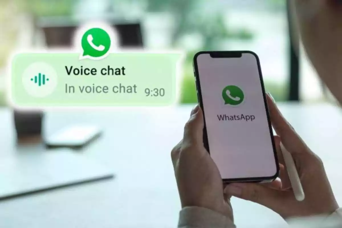 Un móvil abriendo whatsapp con una mesa al fondo. En el lado izquierdo se aprecia el nuevo símbolo de los chats de voz de WhatsApp