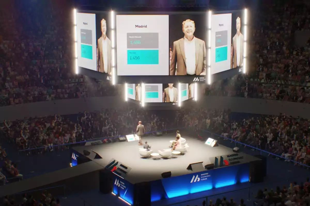 Una conferencia en un auditorio lleno de gente con pantallas grandes mostrando gráficos y a un presentador en el escenario. Una conferencia en un auditorio lleno de gente con pantallas grandes mostrando gráficos y a un presentador en el escenario.