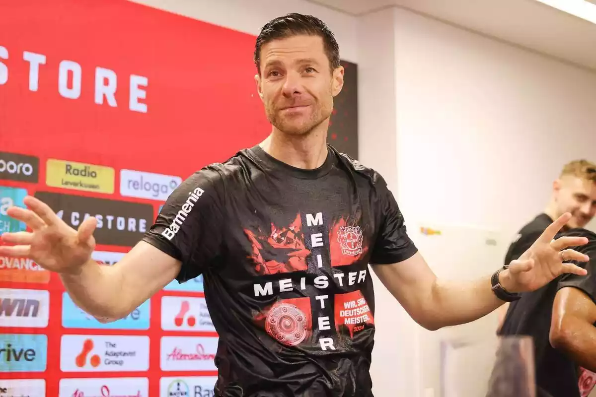 Xabi Alonso durante los festejos del Bayer Leverkusen con la camiseta empapada y los brazos abiertos