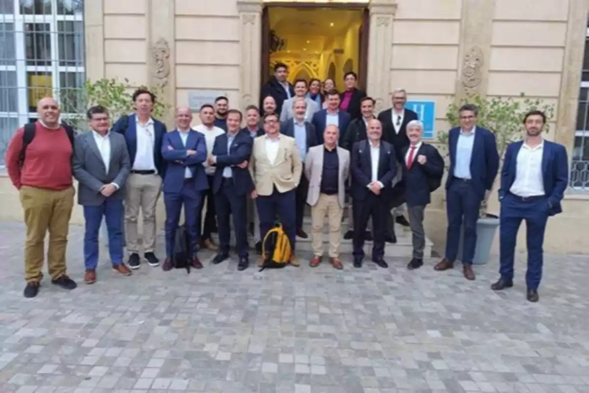 A group of people posing in front of a fancy building.